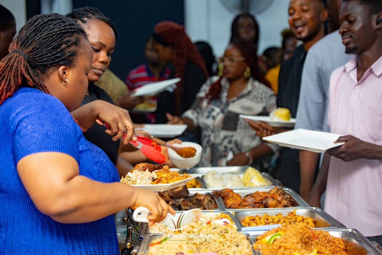 Guests serving themselves from a buffet of rice dishes