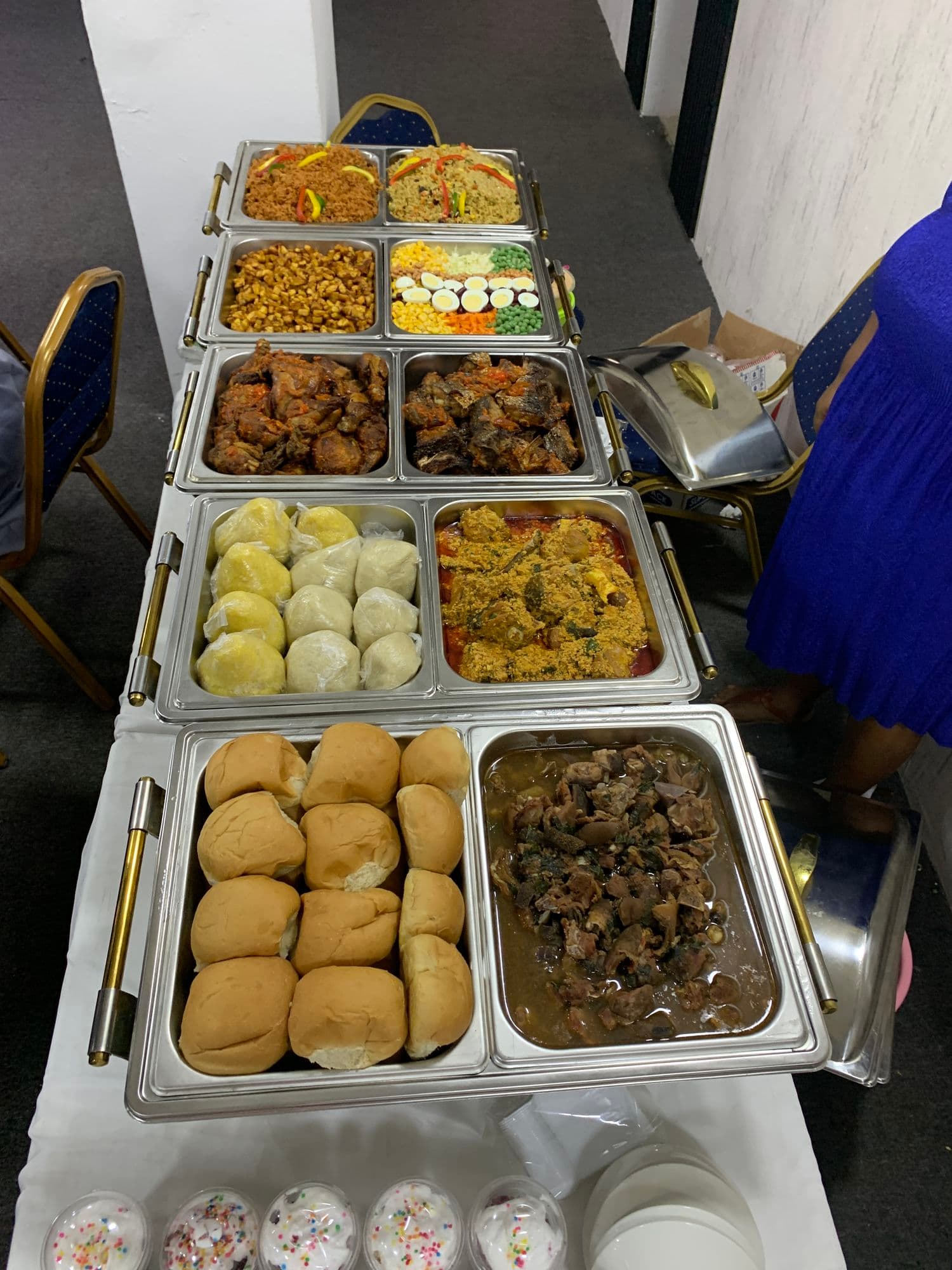 Buffet trays of bread rolls, stews and grilled meat