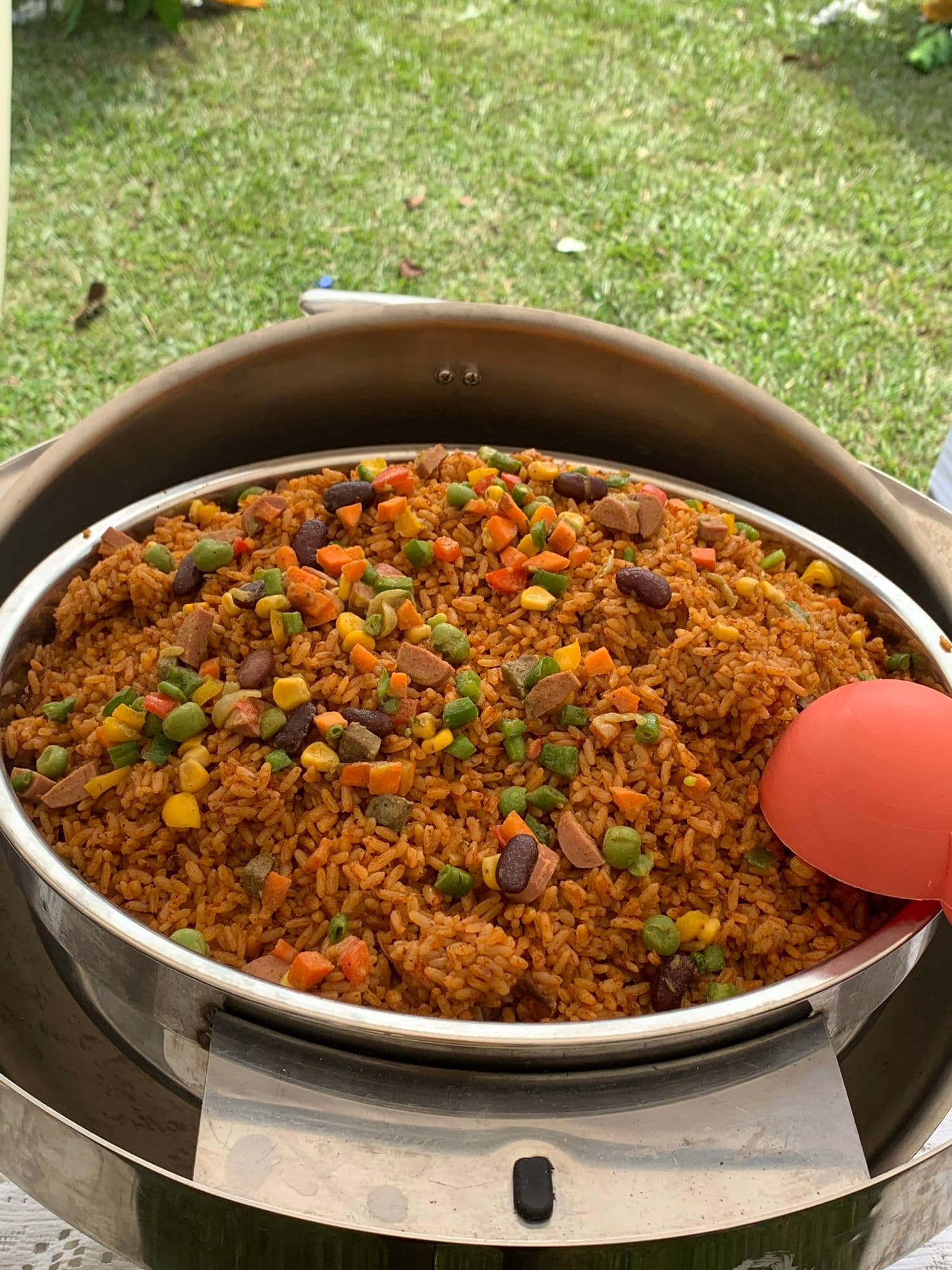 Jollof rice with mixed vegetables in a serving dish
