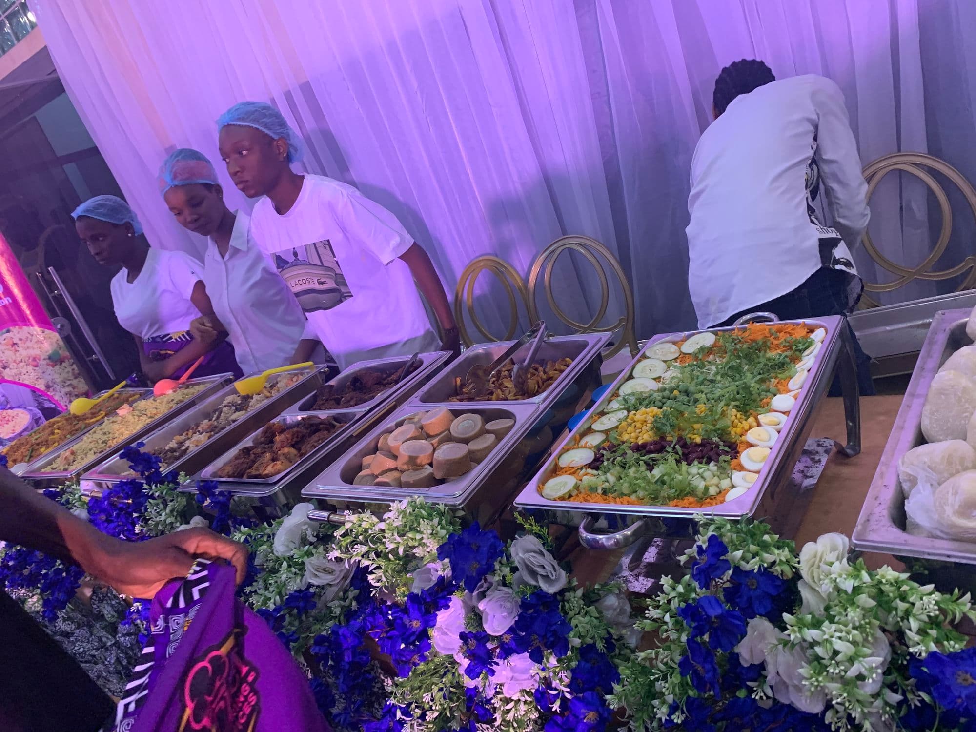 Servers preparing a buffet at an evening event